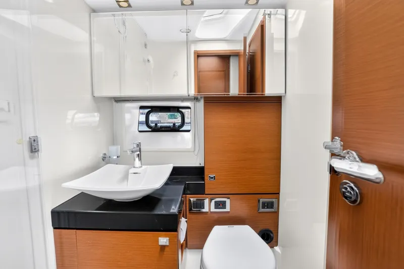 Slide: The Image of Luxurious bathroom interior of 2013 Prestige 620 yacht with modern fixtures and wood accents. - 52