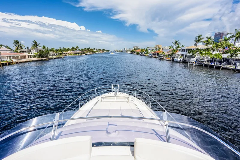 Slide: The Image of Bow view of 2013 Prestige 620 yacht cruising through a scenic waterway. - 23