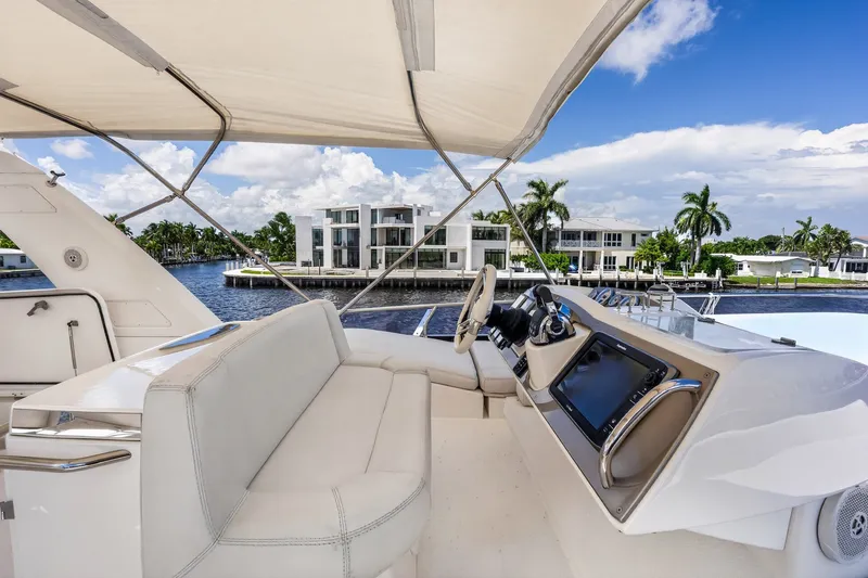 Slide: The Image of Luxurious 2013 Prestige 620 yacht interior with waterfront view, featuring modern helm and seating. - 19