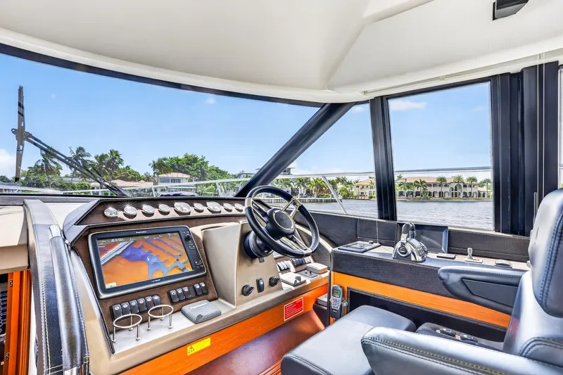 Slide: The Image of Luxurious 2013 Prestige 620 yacht cockpit with navigation system and waterfront view. - 39