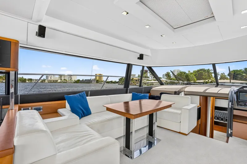Slide: The Image of Luxurious interior of 2013 Prestige 620 yacht with white seating and wooden table. - 34