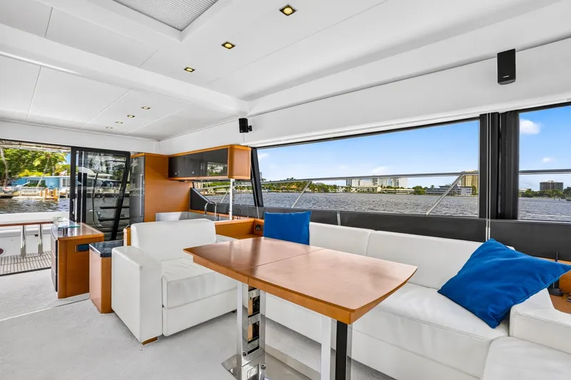 Slide: The Image of Luxurious interior of 2013 Prestige 620 yacht with white seating and blue cushions. - 33