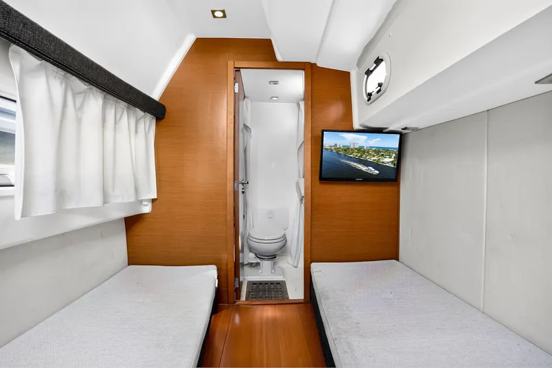 Slide: The Image of Interior of 2013 Prestige 620 yacht cabin with twin beds and bathroom. - 59