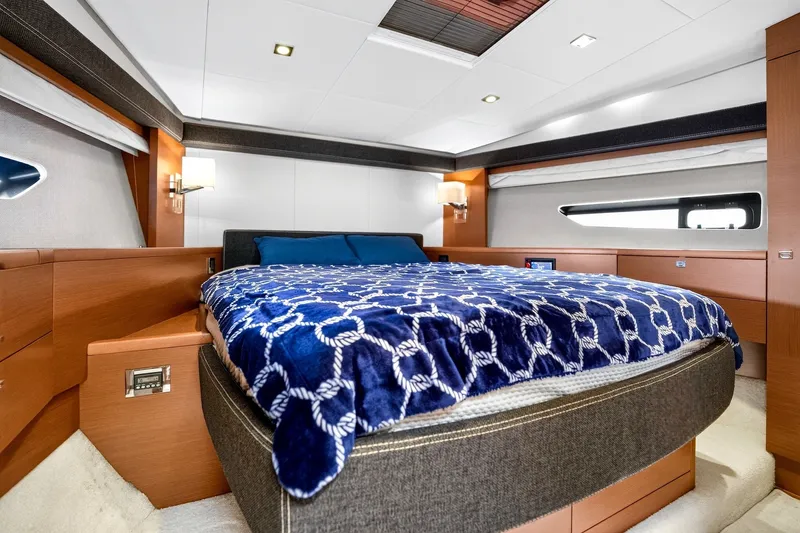 Slide: The Image of Luxurious bedroom interior of 2013 Prestige 620 yacht with modern design and cozy bedding. - 48