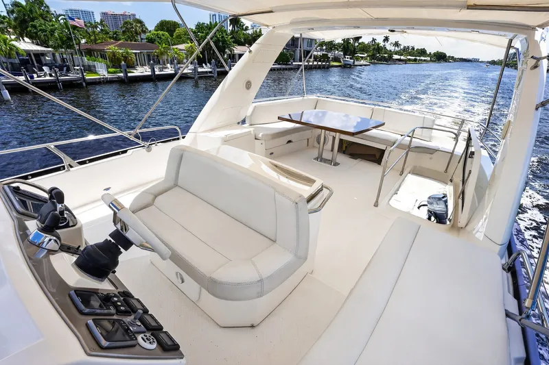 Slide: The Image of Luxurious 2013 Prestige 620 yacht interior with elegant seating and scenic waterway view. - 16