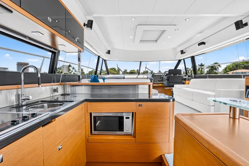 Slide: The Image of Luxurious interior of 2013 Prestige 620 yacht with modern kitchen and seating area. - 25