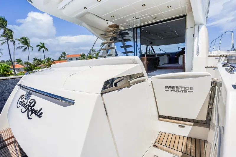 Slide: The Image of Luxury 2013 Prestige 620 yacht with open deck and elegant interior, docked near palm trees. - 61