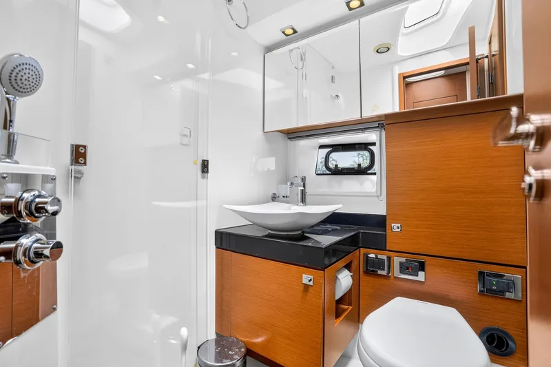 Slide: The Image of Luxurious bathroom in 2013 Prestige 620 yacht with modern fixtures and wood accents. - 53
