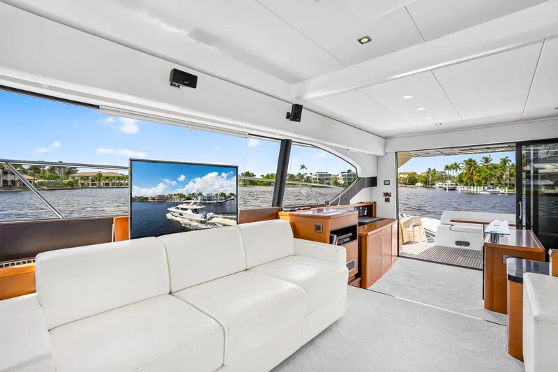 Slide: The Image of Luxurious interior of 2013 Prestige 620 yacht with white seating and waterfront view. - 32