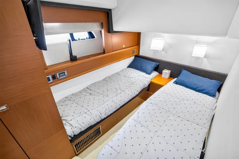 Slide: The Image of Luxurious twin cabin interior of 2013 Prestige 620 yacht with modern decor and cozy bedding. - 54