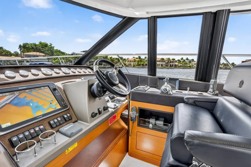 Slide: The Image of Cockpit of 2013 Prestige 620 yacht with navigation system and luxurious seating. - 38