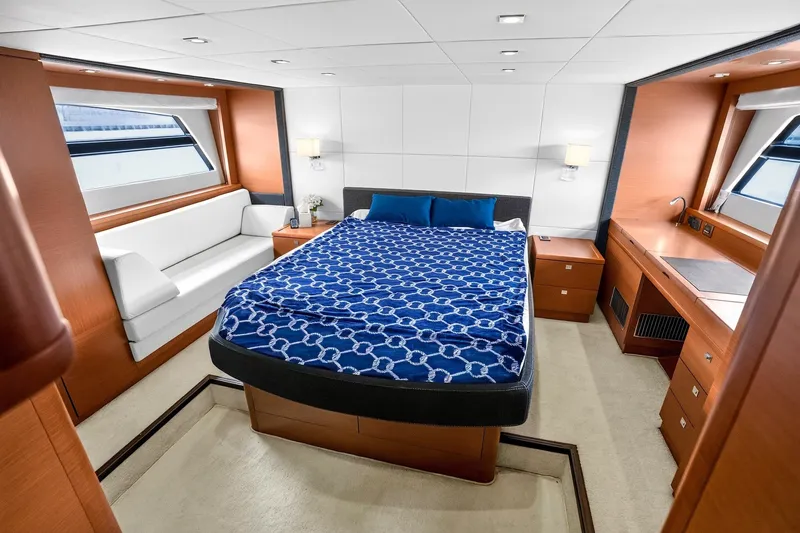 Slide: The Image of Luxurious 2013 Prestige 620 yacht bedroom with elegant wood finish and large windows. - 42