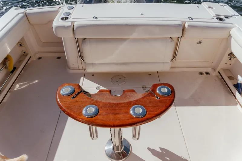 Slide: The Image of Cockpit of 2019 Grady-White Express 330 boat with wooden rod holder. - 17