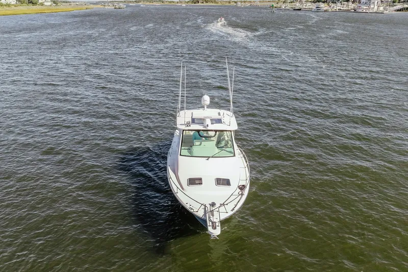 Slide: The Image of 2019 Grady-White Express 330 boat cruising on open water. - 2