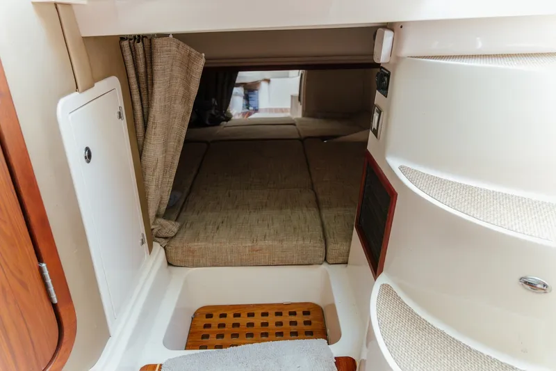 Slide: The Image of 2019 Grady-White Express 330 cabin interior with cozy sleeping area and storage. - 14