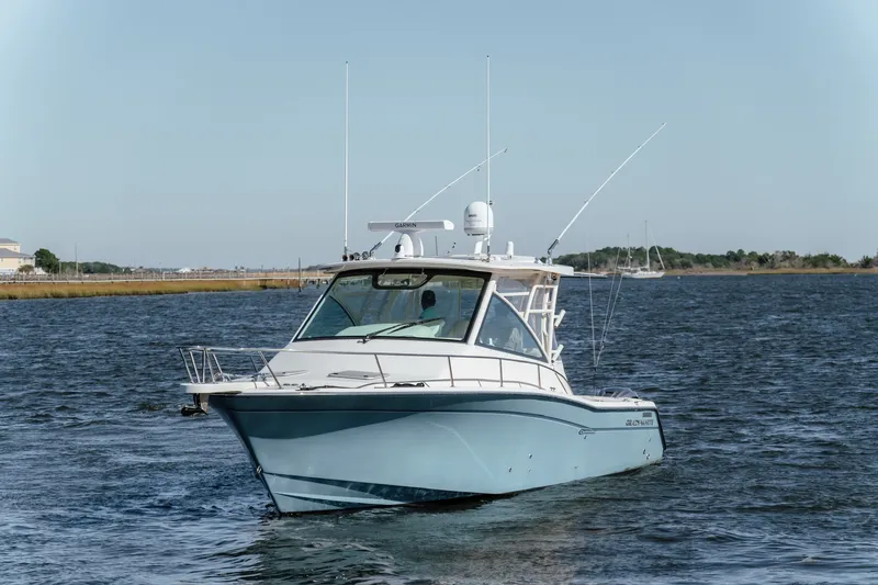 Slide: The Image of 2019 Grady-White Express 330 boat on calm water, clear sky background. - 4