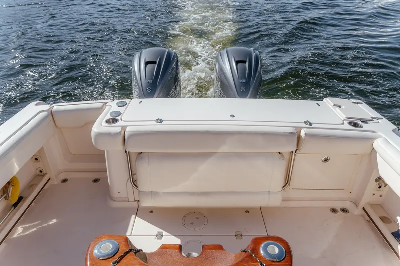Slide: The Image of 2019 Grady-White Express 330 boat with dual outboard engines on water. - 13