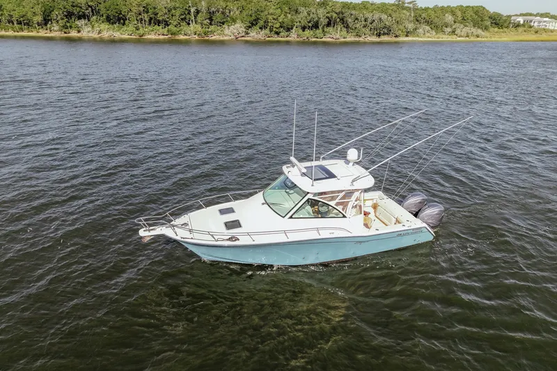 Slide: The Image of 2019 Grady-White Express 330 boat cruising on a scenic river. - 3
