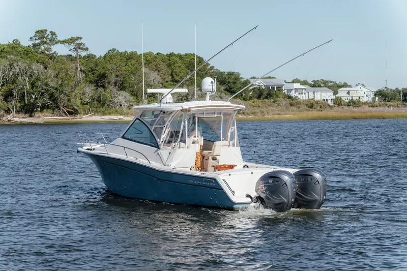 Slide: The Image of 2019 Grady-White Express 330 boat cruising on a scenic waterway. - 9