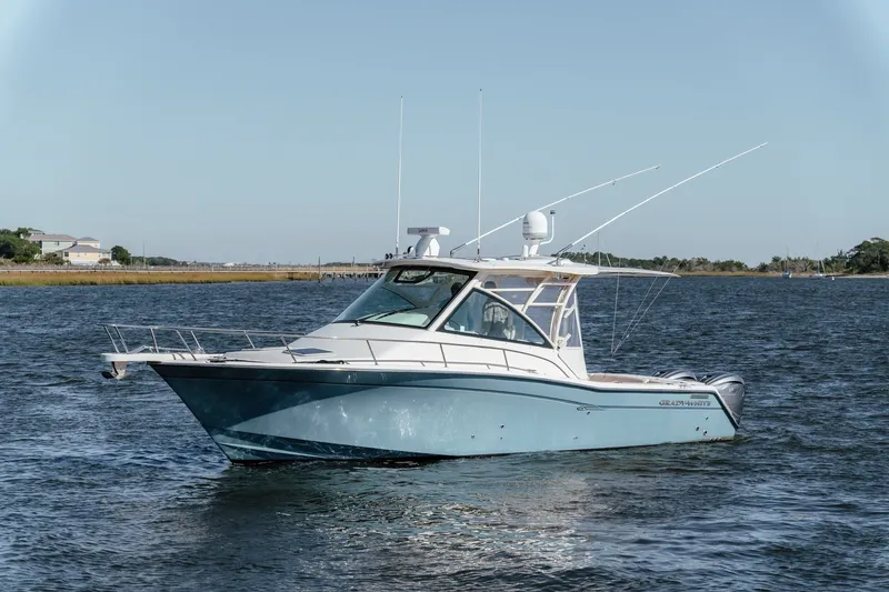 The Image of 2019 Grady-White Express 330 boat on calm water, clear sky background. - 1