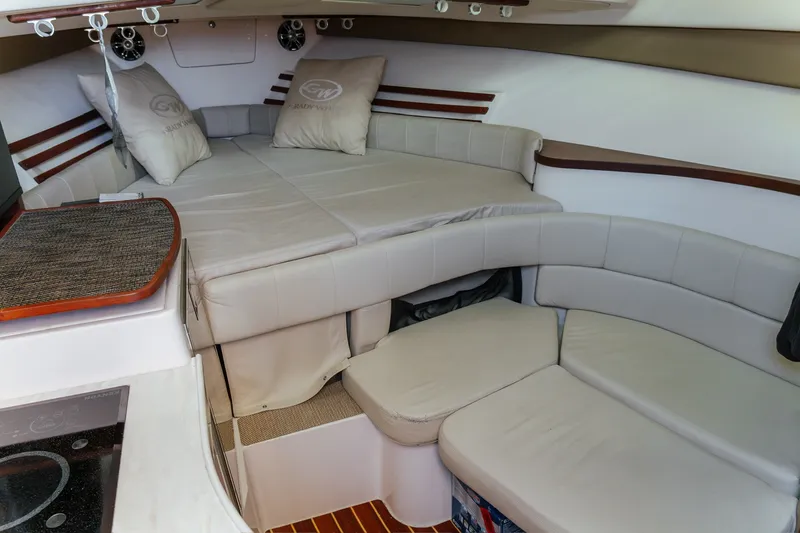 Slide: The Image of 2019 Grady-White Express 330 cabin interior with cozy seating and bedding. - 15