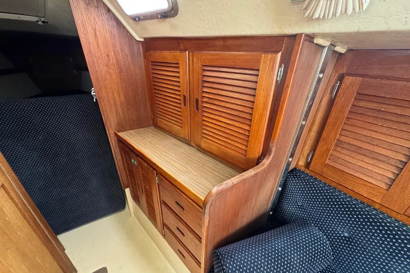 Slide: The Image of Interior of 1986 Catalina 38 sailboat with wooden cabinetry and blue upholstery. - 30