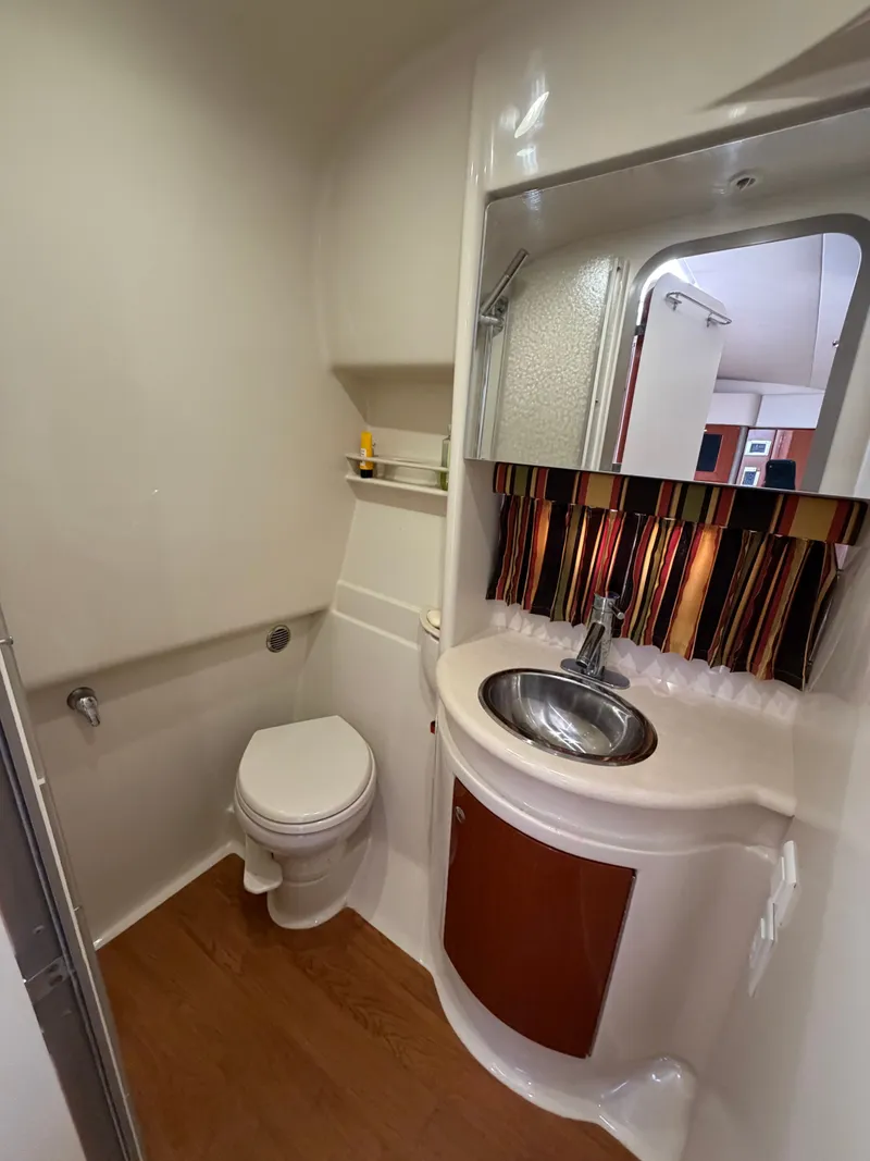 Slide: The Image of Bathroom in a 2009 Formula 34 Performance Cruiser with toilet, sink, and mirror. - 14