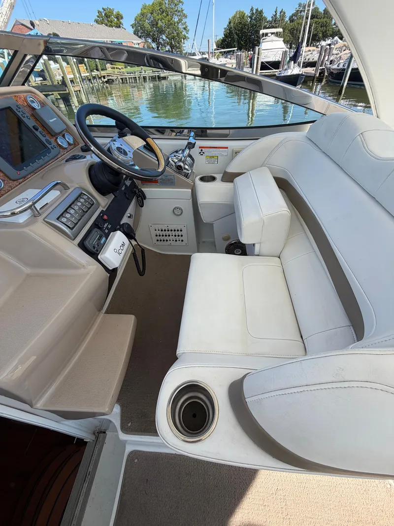 Slide: The Image of Interior of a 2009 Formula 34 Performance Cruiser with white seating area and helm console. - 9