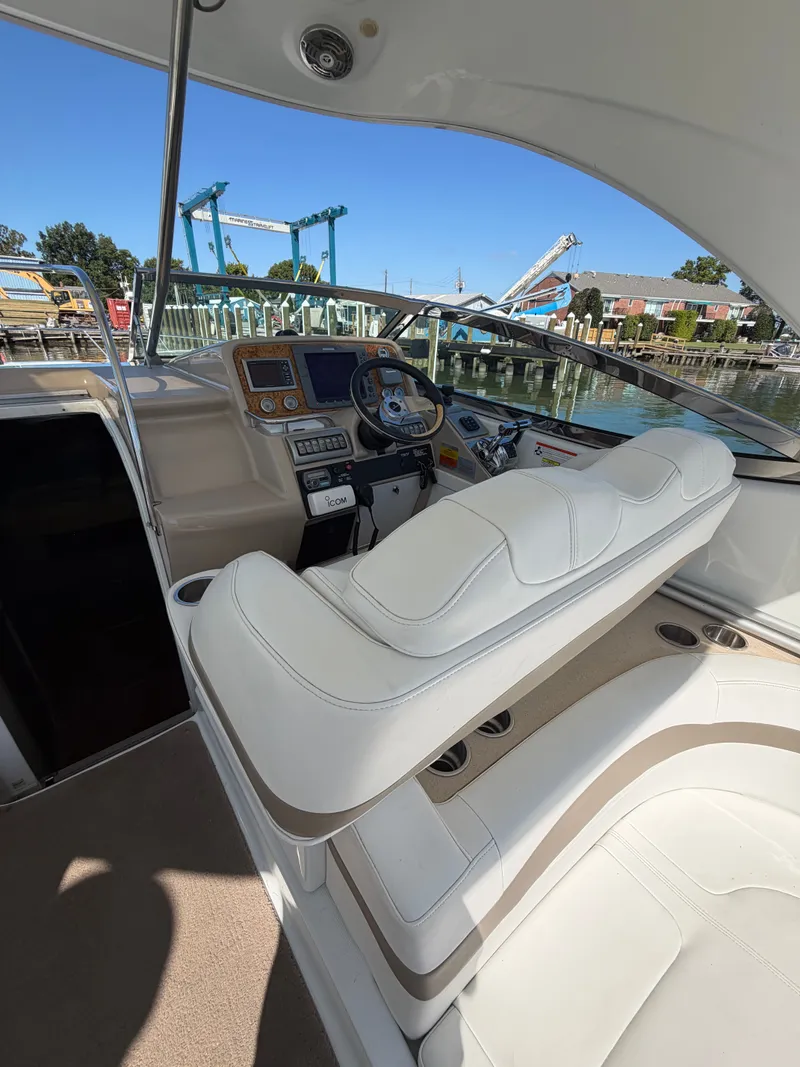 Slide: The Image of The cockpit of a 2009 Formula 34 Performance Cruiser with white leather seats and modern helm console. - 8