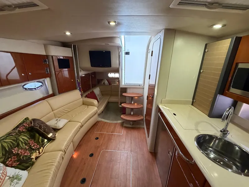 Slide: The Image of Interior of a luxury yacht with leather sofas, wooden floors, and a small kitchenette. - 12
