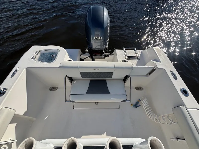 Slide: The Image of The image shows the stern of a 2020 Tidewater 210 CC Adventure boat with an outboard motor. - 14