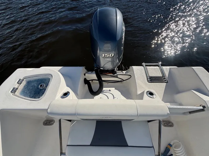 Slide: The Image of The boat features a Yamaha 150 engine and a swim ladder at the stern. - 15