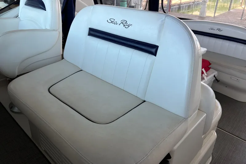 Slide: The Image of 2006 Sea Ray 40 Sundancer interior seating with white upholstery and logo detailing. - 4