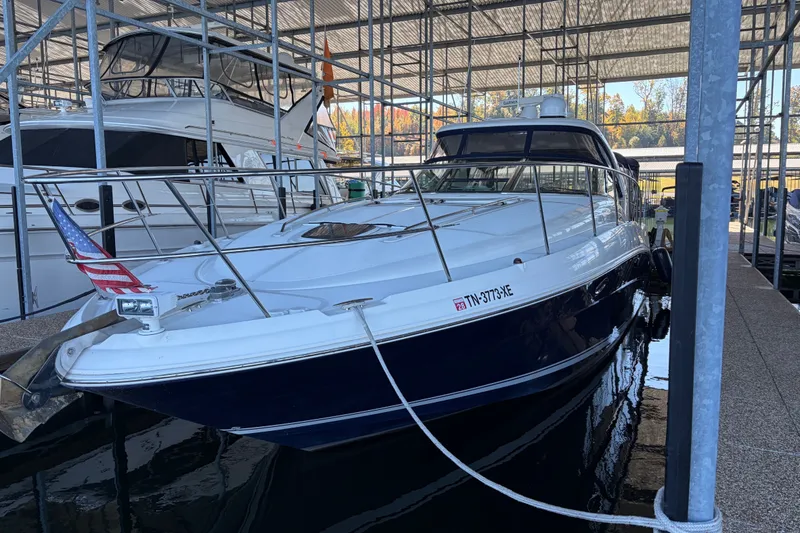 The Image of 2006 Sea Ray 40 Sundancer yacht docked in a marina under a metal canopy. - 0