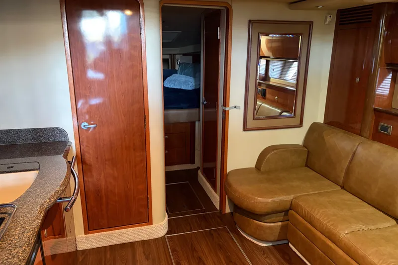 Slide: The Image of Interior of 2006 Sea Ray 40 Sundancer yacht with leather seating and wooden finishes. - 8
