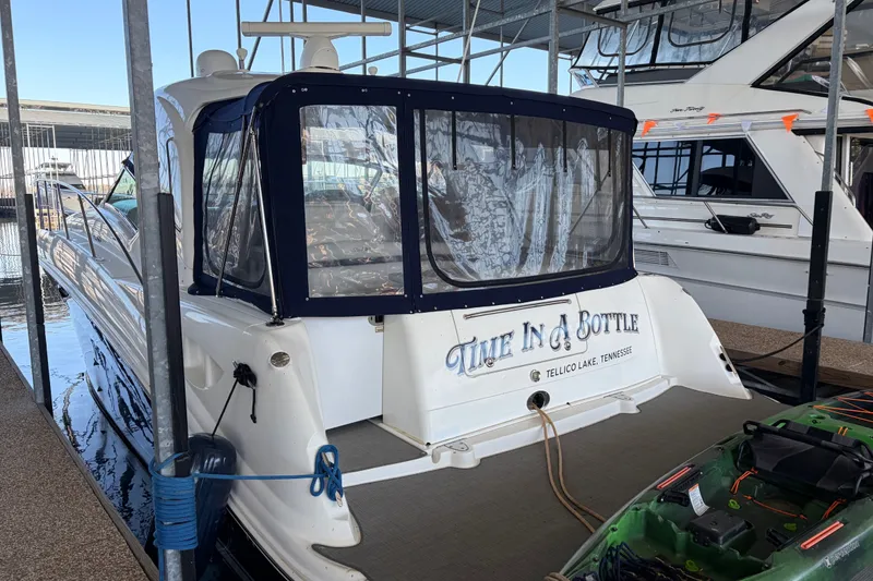 Slide: The Image of 2006 Sea Ray 40 Sundancer docked, featuring "Time In A Bottle" on the stern. - 1