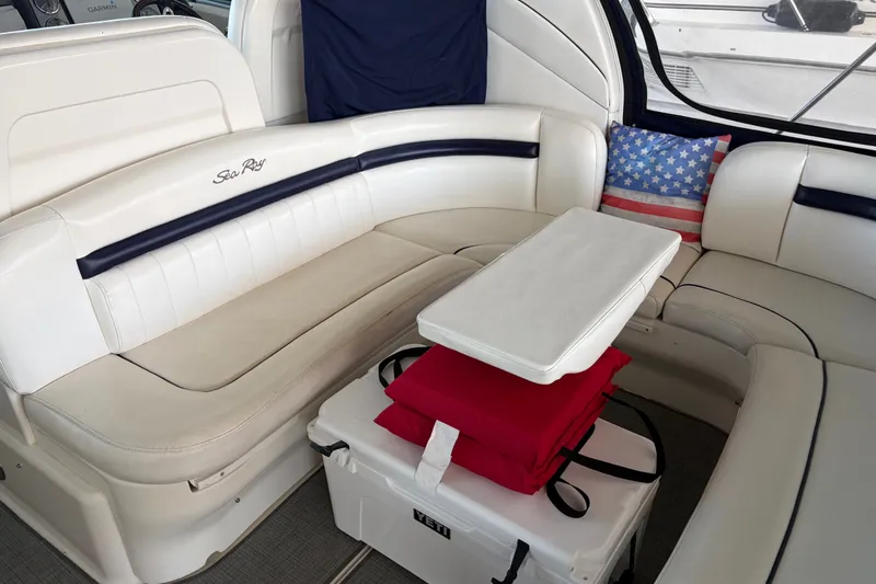 Slide: The Image of Luxurious 2006 Sea Ray 40 Sundancer interior with white seating and American flag pillow. - 2