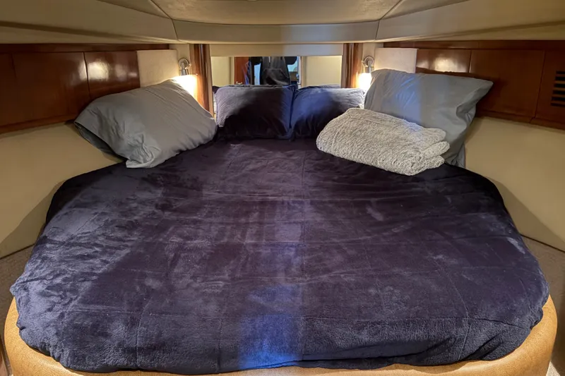 Slide: The Image of Cozy cabin bed in 2006 Sea Ray 40 Sundancer yacht with plush bedding and pillows. - 12