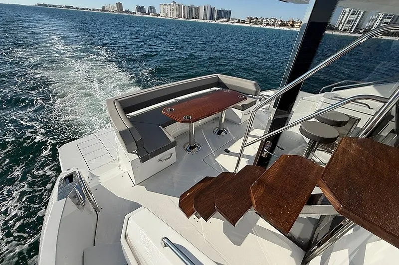 Slide: The Image of 2023 Cruisers Yachts 60 Fly deck with seating and ocean view. - 32
