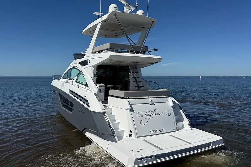 Slide: The Image of 2023 Cruisers Yachts 60 Fly on calm water, rear view, sunny day. - 4