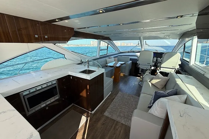 Slide: The Image of Luxurious interior of 2023 Cruisers Yachts 60 Fly with modern kitchen and seating area. - 10