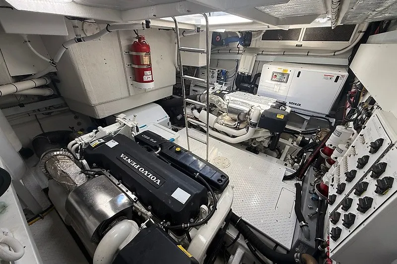 Slide: The Image of Engine room of 2023 Cruisers Yachts 60 Fly, featuring Volvo Penta engines and Kohler generator. - 48