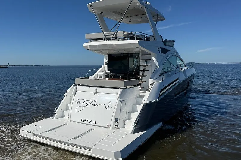 Slide: The Image of 2023 Cruisers Yachts 60 Fly luxury yacht on calm waters, rear view. - 5