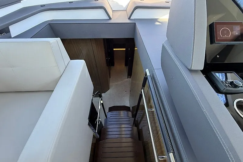 Slide: The Image of Interior view of 2023 Cruisers Yachts 60 Fly, featuring sleek stairs and modern design. - 13