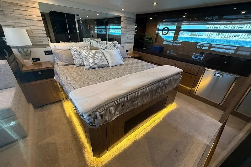 Slide: The Image of Luxurious bedroom interior of 2023 Cruisers Yachts 60 Fly with modern decor and ambient lighting. - 25
