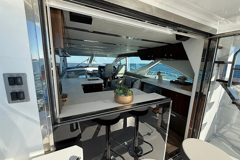 Slide: The Image of Luxurious interior of 2023 Cruisers Yachts 60 Fly with modern kitchen and seating area. - 8