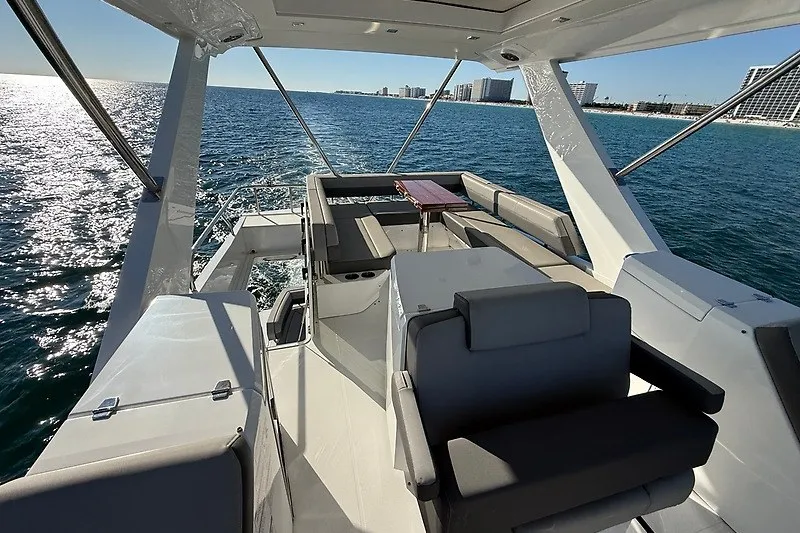 Slide: The Image of 2023 Cruisers Yachts 60 Flybridge with luxurious seating, overlooking ocean and city skyline. - 39