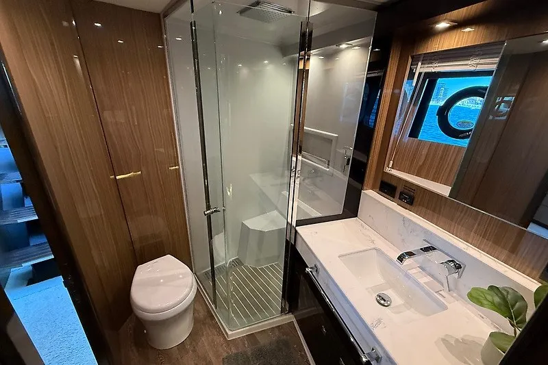 Slide: The Image of Luxurious bathroom in 2023 Cruisers Yachts 60 Fly with glass shower and modern fixtures. - 18