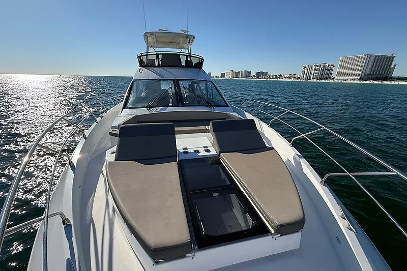 Slide: The Image of 2023 Cruisers Yachts 60 Fly on open water, city skyline in background. - 34