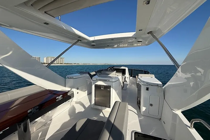 Slide: The Image of 2023 Cruisers Yachts 60 Flybridge, luxurious deck view, open sea, clear sky. - 43
